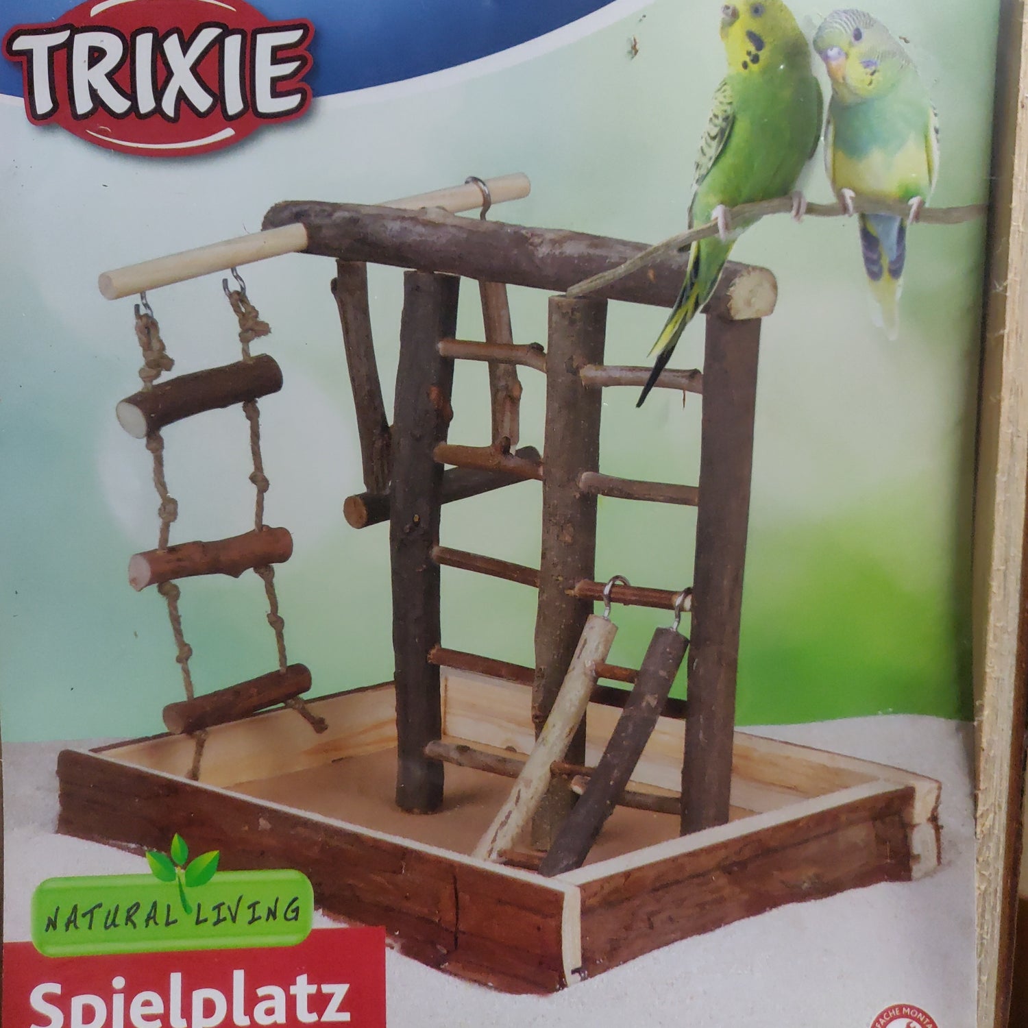 Et Natural Living kanarier bur med bølgende papegøjer på.