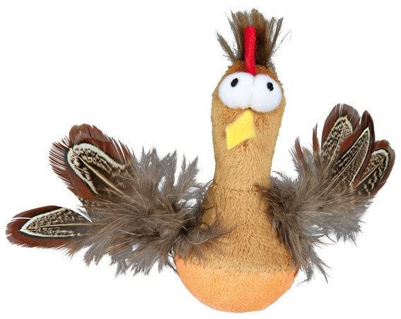 En Roly-poly Trixie kylling legetøjskylling med fjer på hovedet.