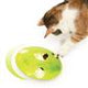 En kat, der dyrker fysisk aktivitet og leger med et CATIT PLAY TREAT "SPINNER" legetøj på en hvid overflade.