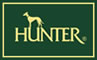 Hunter-logoet af høj kvalitet på en grøn baggrund med produktet Hundehalsbånd, Hunter, ægte blødt ko læder, COGNAC.