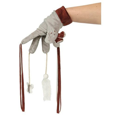 En kvindes hånd, der holder et par Trixie-handsker med dristige kvaster.
