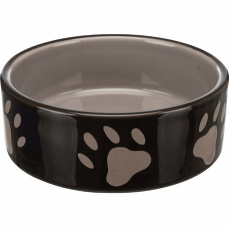 En sort Foderskål i keramik til hund med poteaftryk på, lavet af keramik og tåler opvaskemaskine, fra Trixie.